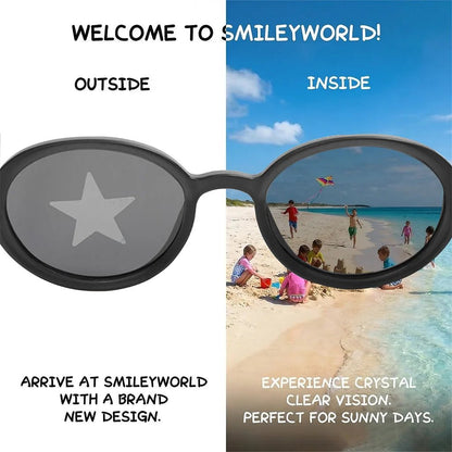 Comparison view of SmileyWorld obsidian black oval kids sunglasses demonstrating seamless lens printing technology. The left 'outside' view shows a star design on the lens, while the right 'inside' view reveals crystal clear vision of children playing on a sunny beach.
